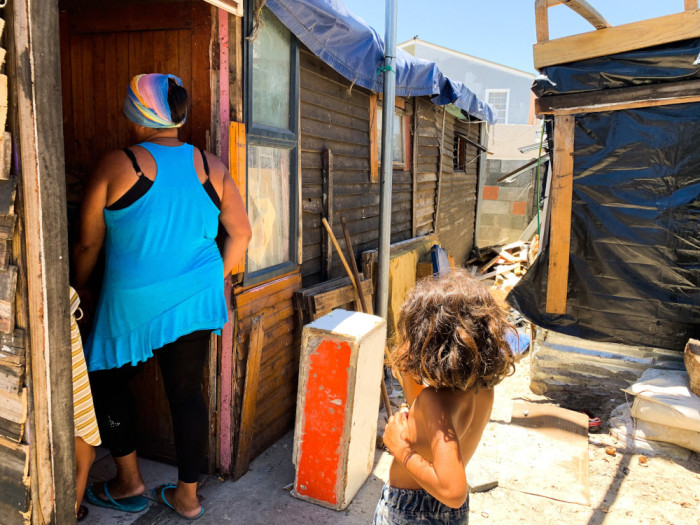 Resident Yolanda Daniels walks into one of the informal structures on the Beacon Valley premises in Mitchells Plain. Picture: Kaylynn Palm/Eyewitness News
