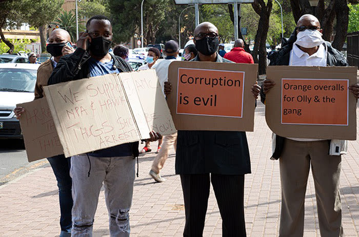 FILE: Members of the People’s Movement hold placards outside the Bloemfontein Magistrates Court on 2 October 2020 where 7 suspects are appearing on corruption-related charges related to a multi-million rand Free State asbestos project. Picture: Xanderleigh Dookey/Eyewitness News