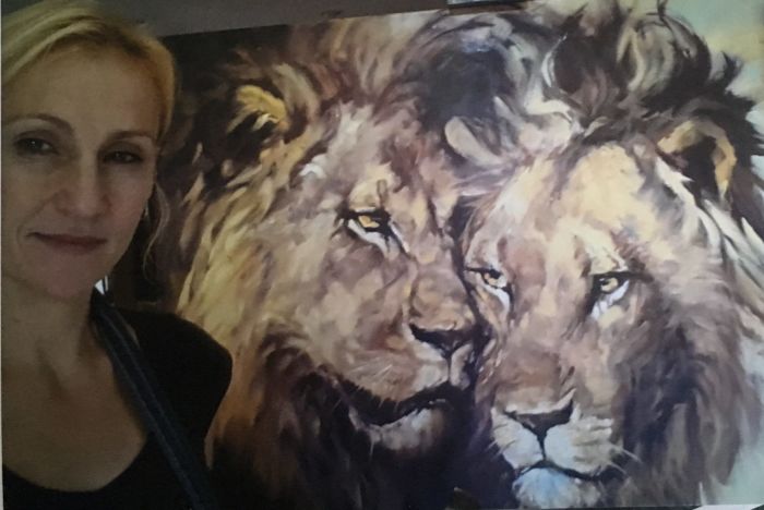 Karin Kruger with one of her famous paintings.  Photo: KarinKruger.co.za