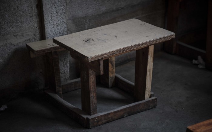 The desks and chairs of the pupils are uncomfortably small. 