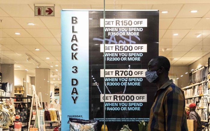 Man walks past a Black Friday store special in Greenstone shopping centre.