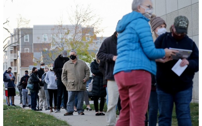 Voters wait to cast their ballots on the final day of early voting on 2 November 2020 in Cedar Rapids, Iowa.