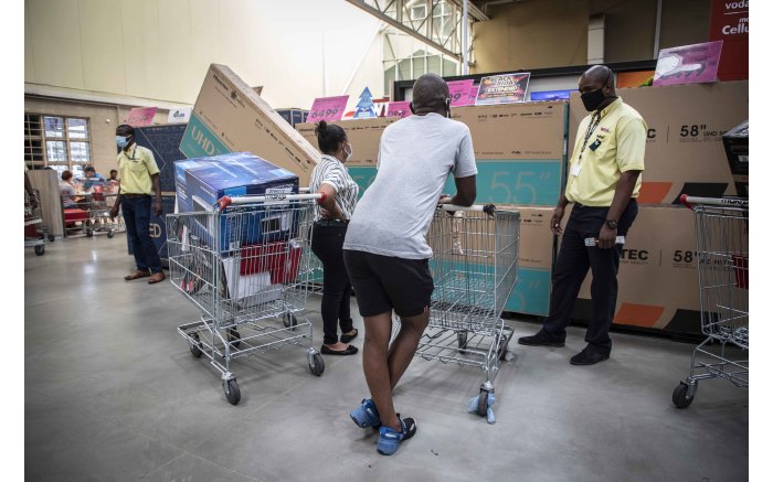 Shoppers speaking to a Makro Woodmead salesman about the latest Black Friday television deals.