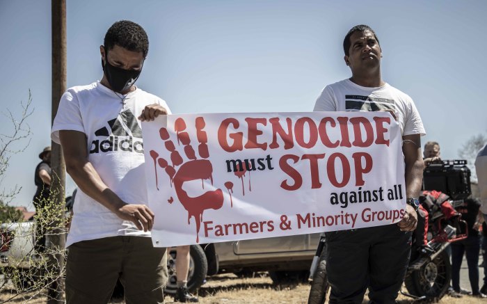 Protesters from the farmers' organisation hold a placard against violence against farmers and minority groups. Picture: Abigail Javier/EWN