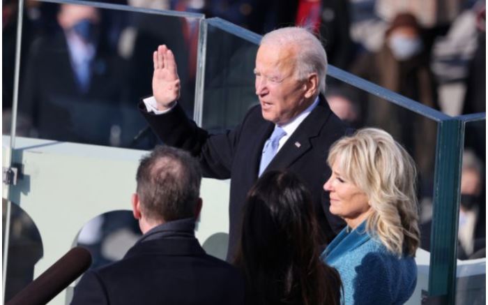 Joe Biden is sworn in as US President as his wife Jill Biden looks on.