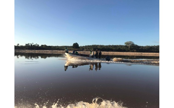 A boat heads out on the Buzi River with food and water to provide aid to those affected by Cyclone Idai.