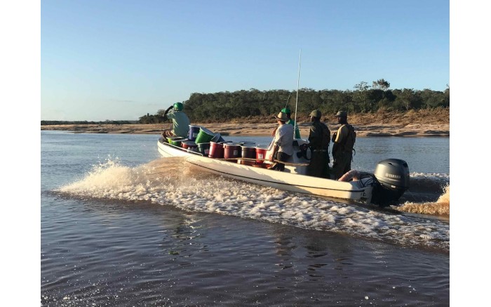 A relief aid boat looks for victims of Cyclone Idai along the Buzi river.