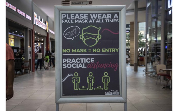 Multiple signs at Greenstone shopping centre reminding shoppers to observe Covid-19 health regulations.