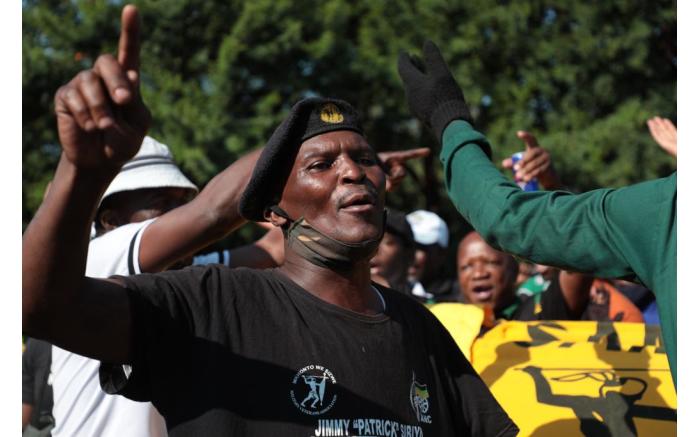 Supporters of ANC secretary-general Ace Magashule sing and dance outside the Bloemfontein Magistrates Court.