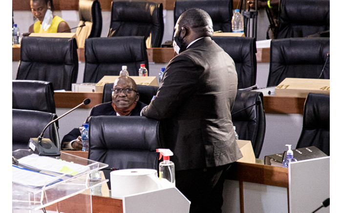 Former President Jacob Zuma in conversation before the start of proceedings.