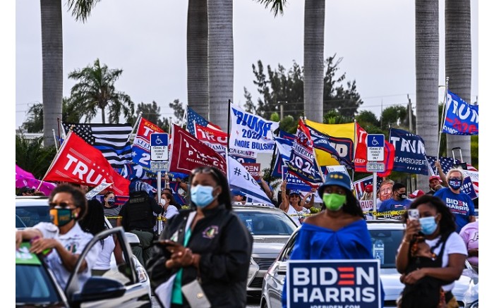 Supporters listen to US Democratic vice presidential nominee Kamala Harris at a drive-in rally in Florida, on 31 October.